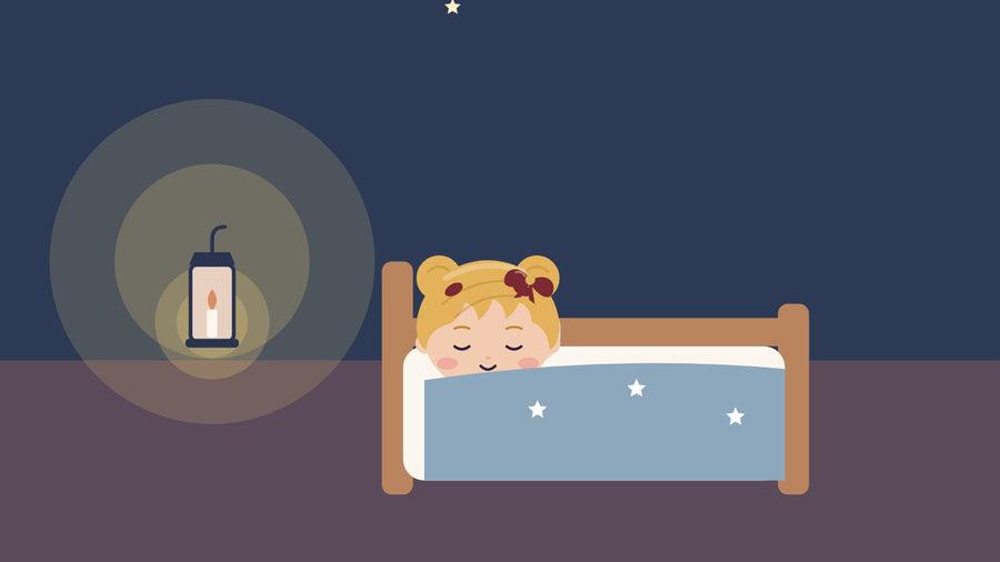 When your child is afraid of the dark. A girl lies safely in her bed in the evening with a small glowing flashlight
